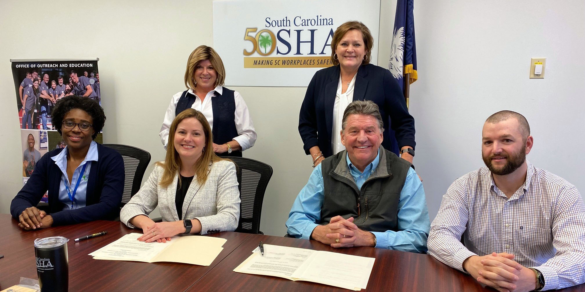 CAGC Staff Members Dave Simpson, Leslie Clark and Jacob Garmon sign the SC OSHA Alliance